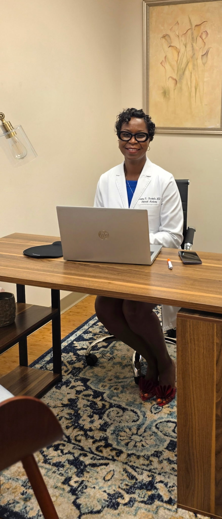 Dr. Leemu Kerkula seated in her medical office